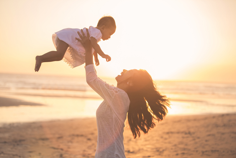 Mother and Baby in the Beach at Sunset